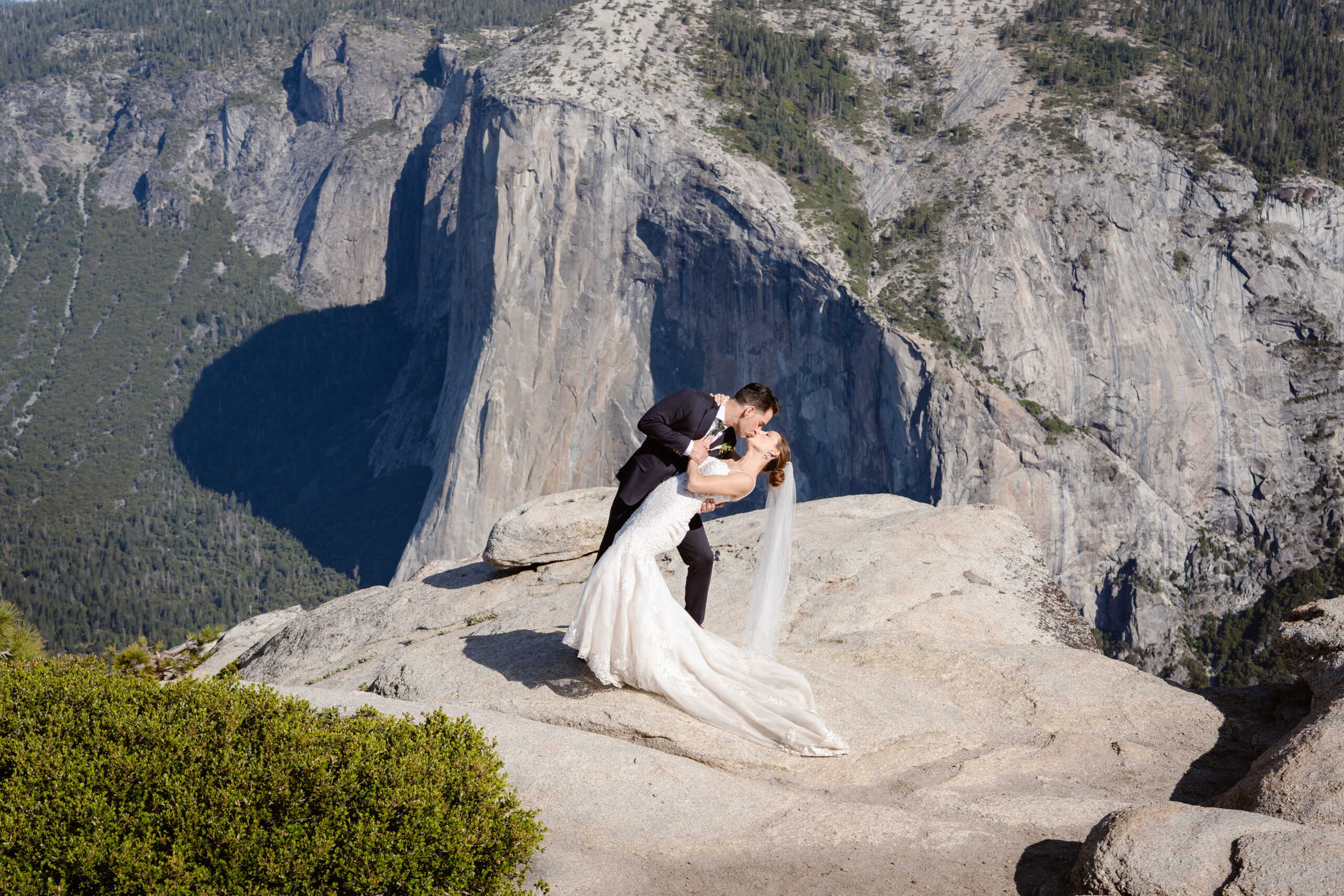 A couple that eloped in Yosemite shares a kiss at Taft Point
