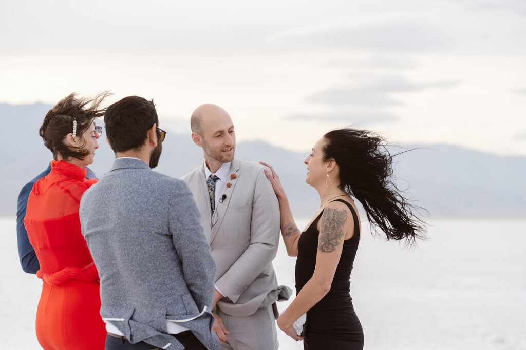 strong wind is whipping up the hair and clothes of elopement guests