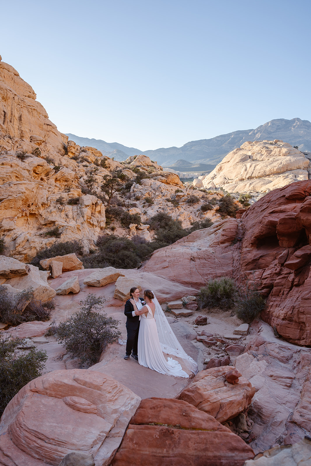 Two brides pause to catch their breath while hiking in Red Rock Canyon National Conservation Area